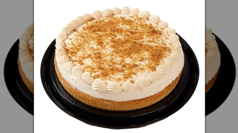 Kirkland Signature pumpkin cheesecake with whipped topping on a white background.