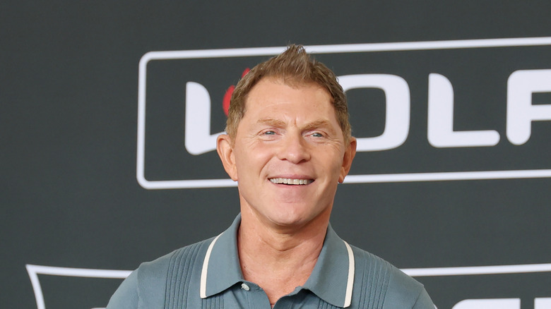 Bobby Flay smiling wearing casual attire.