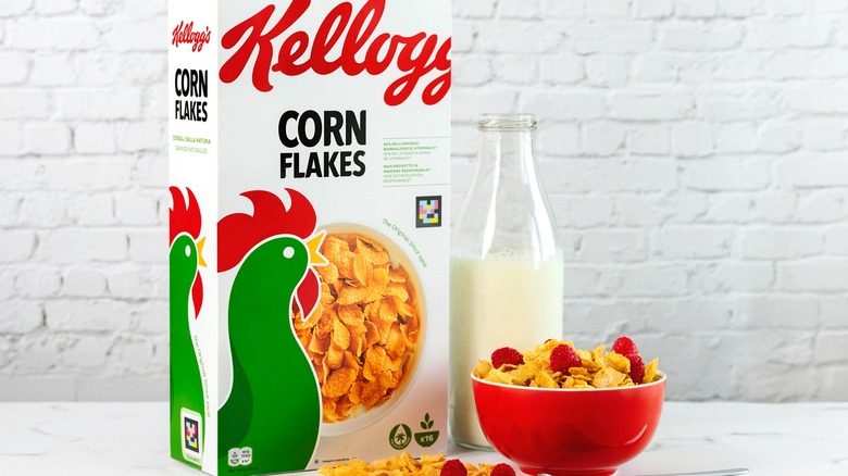Box of Kellogg's Corn Flakes, bottle of milk, and bowl of cereal