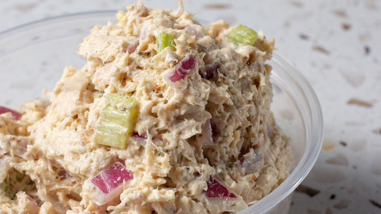 tuna salad with celery and onions in a plastic container
