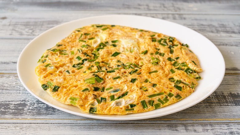 chive omelet on a white plate