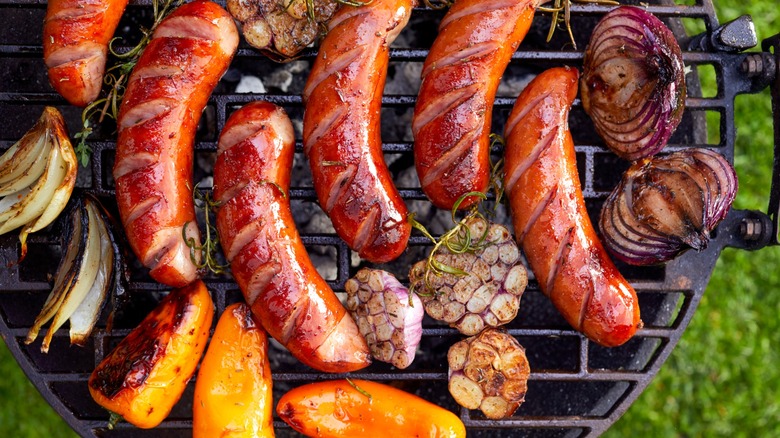 Sausages and vegetables on outdoor grill
