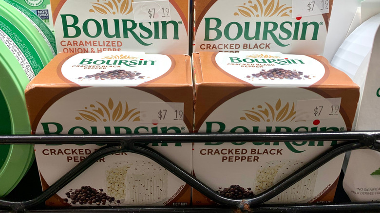 A shelf of packaged Boursin cheese in black pepper flavor