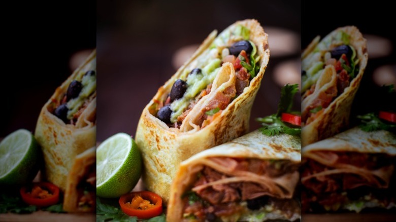 Close-up of a burrito with black beans and guacamole