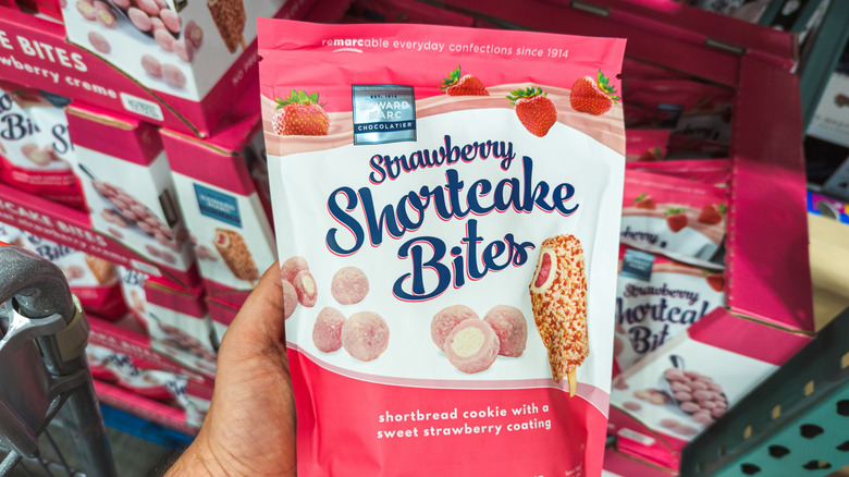 Someone holding a Costco strawberry shortcake bites bag in the store.