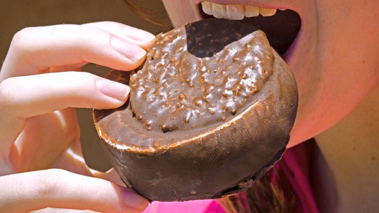A person bites into an It's-It ice cream sandwich