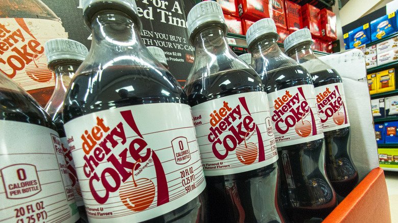 Diet Cherry Coke bottles on a store shelf