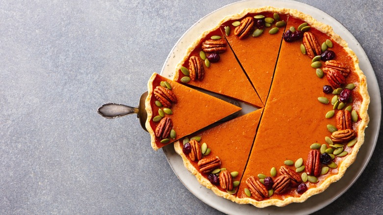 Pumpkin pie on a white plate.