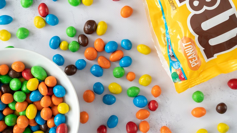 M&Ms in bowl and scattered across table