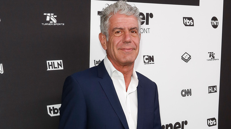 Anthony Bourdain attending a Turner Broadcasting event in a navy blue suit