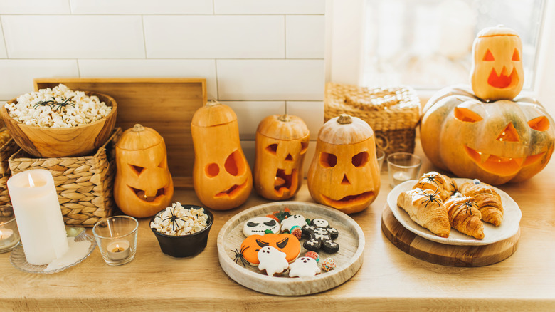 Halloween-shaped cookies, carved pumpkins, and snacks
