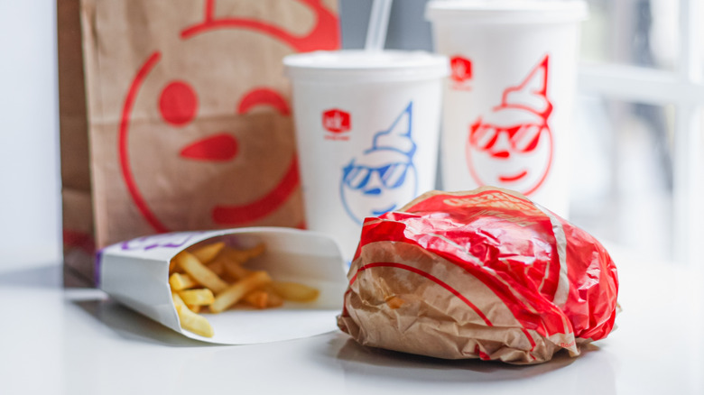 Jack in the Box burger, fries, and drinks on countertop