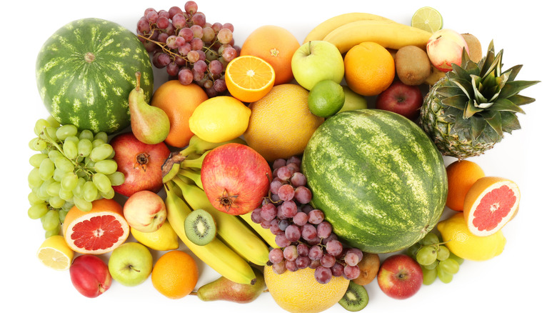 A variety of fresh fruit against white background.