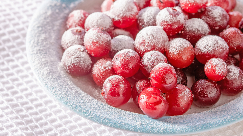 Close up of dish of cranberries sprinkled with powdered sugar