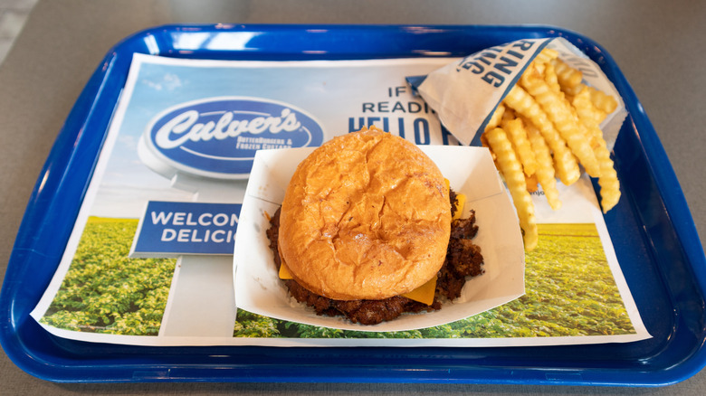 A plastic tray with Culver's burger and fries