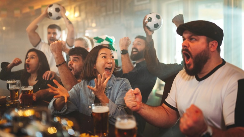 Soccer fans watching game in pub