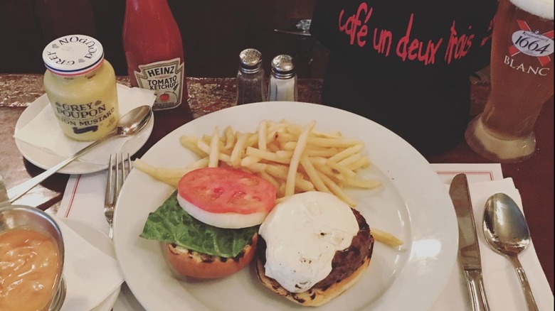a plate of burger and fries at Cafe Un Deux Trois