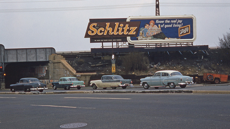 A Schlitz billboard advertisement on a highway during the early 1960s