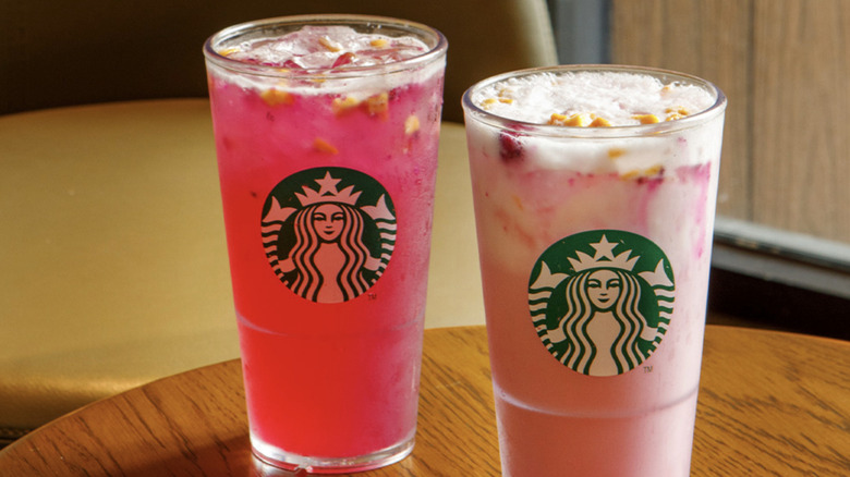 Pink Starbucks refreshers on a wood table in the restaurant
