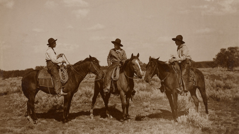 Three cowboys on horses