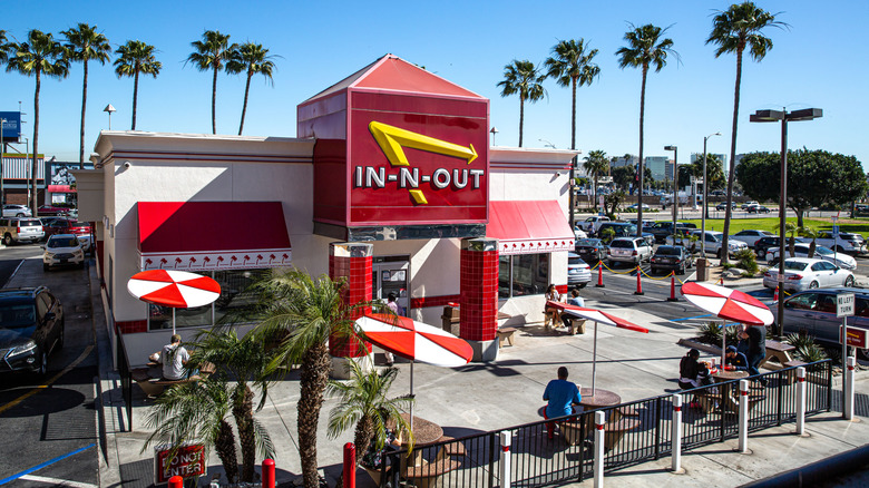 Exterior of an In-N-Out Burger location with palm trees
