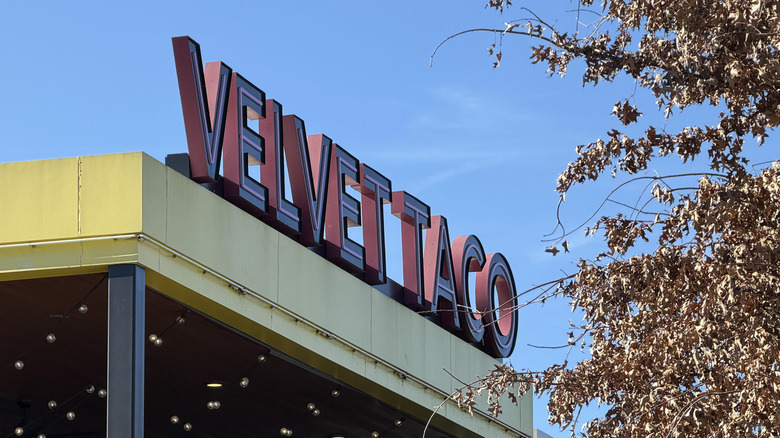 A Velvet Taco sign above the entrance to the restaurant.