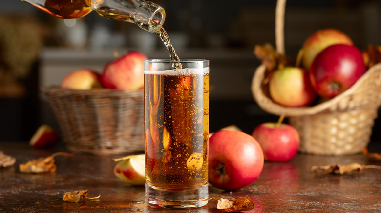 Pouring apple cider into a glass