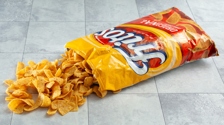Closeup of a pile of Fritos Original chips spilling out from bag