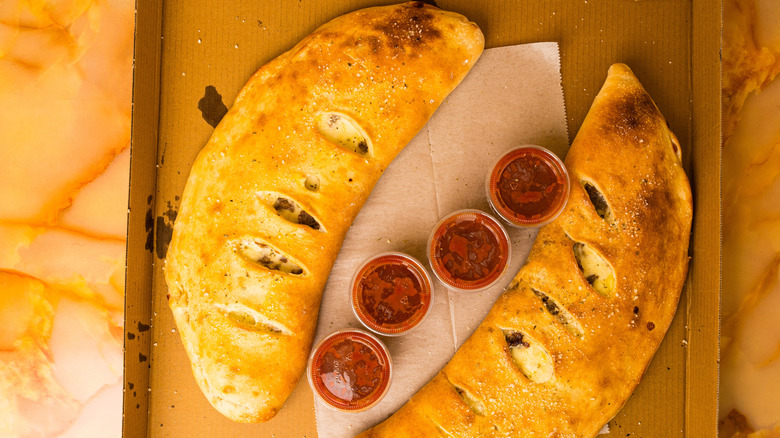 Calzones in a box with marinara sauce