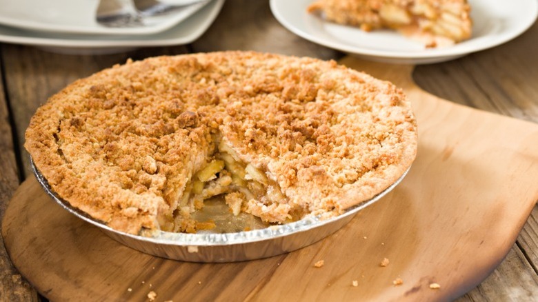 A Dutch apple pie with a slice cut out.