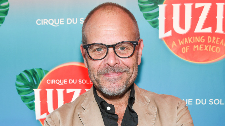 Alton Brown smiling on red carpet for Cirque du Soleil event