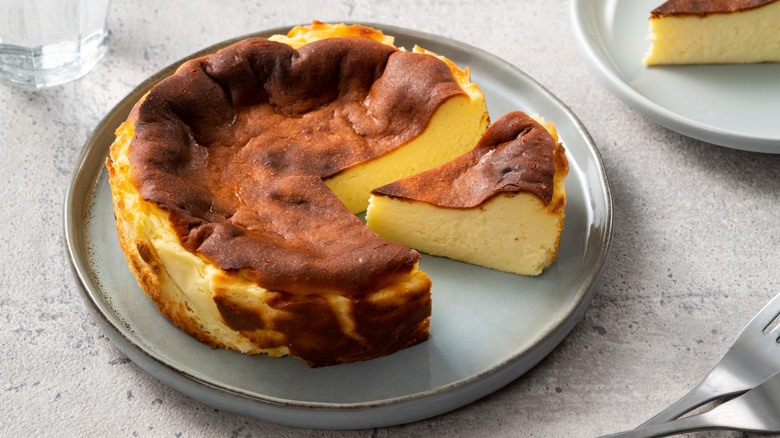 Basque cheesecake with slice cut out of it.