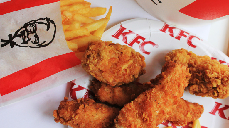 Fries and chicken tenders on top of KFC branded packaging