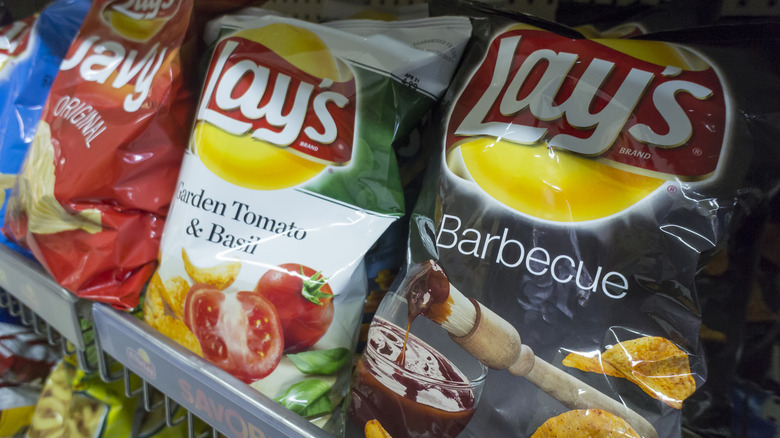 Bags of Lay's potato chips on a store shelf