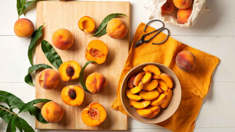 Whole, halved, and sliced fresh peaches
