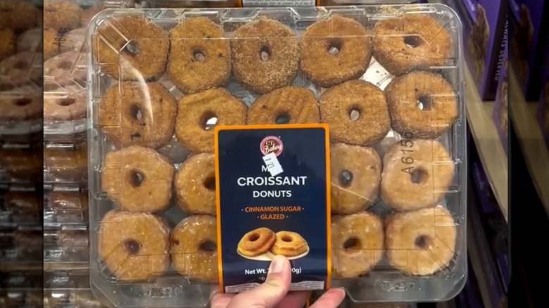 Hand holding a package of the CT Bakery Mini Croissant Donuts available at Costco