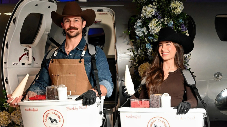 The Cannoli Cowboy and Cannoli Cowgirl pose with their mobile vendor trays