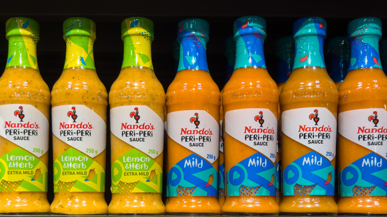Assorted bottles of Nando's Chicken Peri Peri sauce