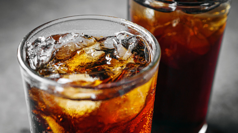 Bubbly cola in a glass with ice