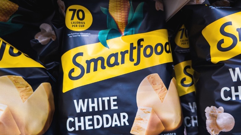 Several bags of Smartfood white cheddar popcorn on a shelf