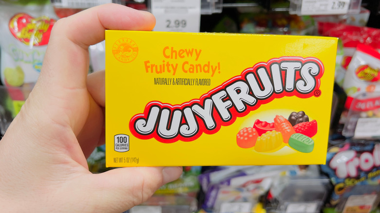 Hand holding a box of Jujyfruits candy