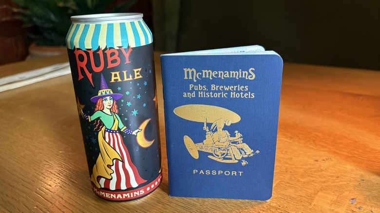 A can of McMenamins Ruby Ale and a Passport book