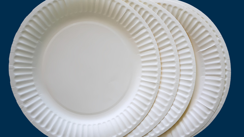 White paper plates on a blue background
