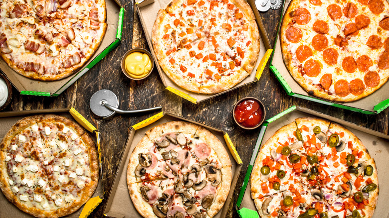 A variety of pizzas in boxes