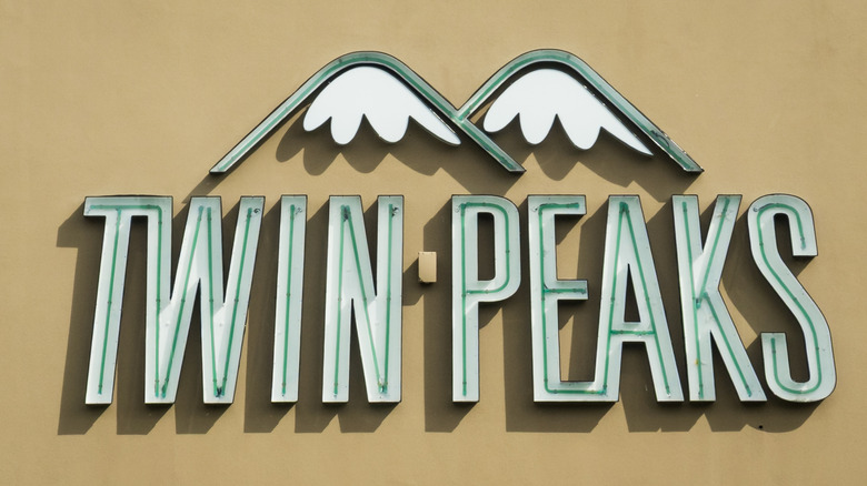 Twin Peaks restaurant logo built on the side of a building.