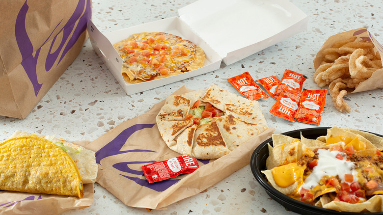 A selection of dishes from Taco Bell, with packets of hot sauce