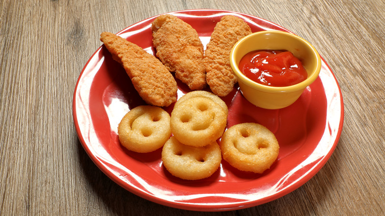 Kids' meal of three chicken strips, potato smiles, and ketchup