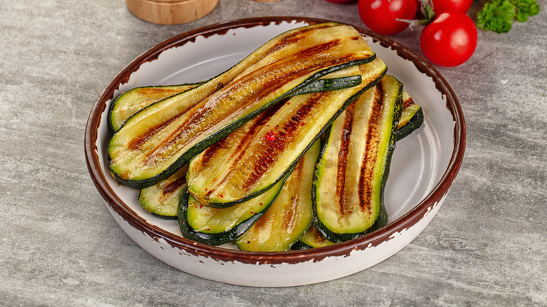 grilled zucchini slices in a white bowl