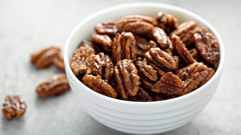 Candied pecans in white bowl