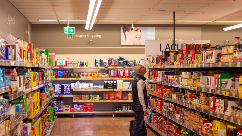 A man looks through the selection at Aldi